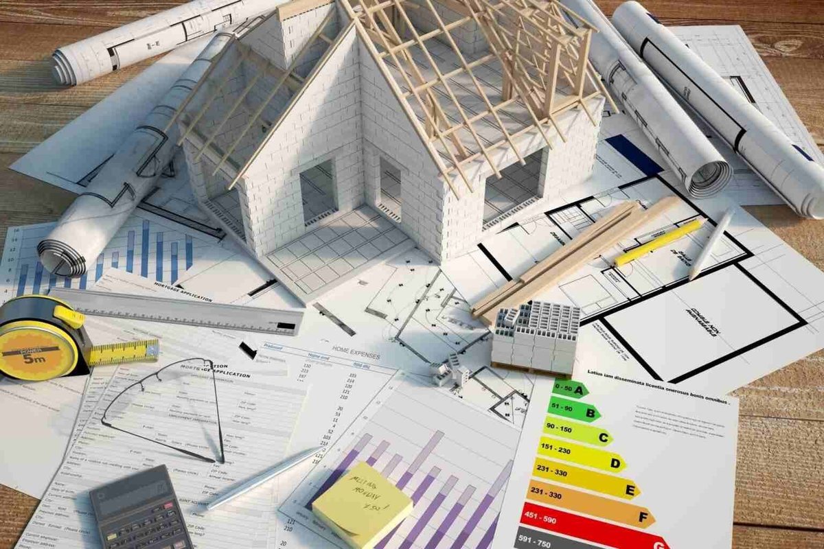 Plans de rénovation, étiquette énergétique et devis posés sur une table de travail